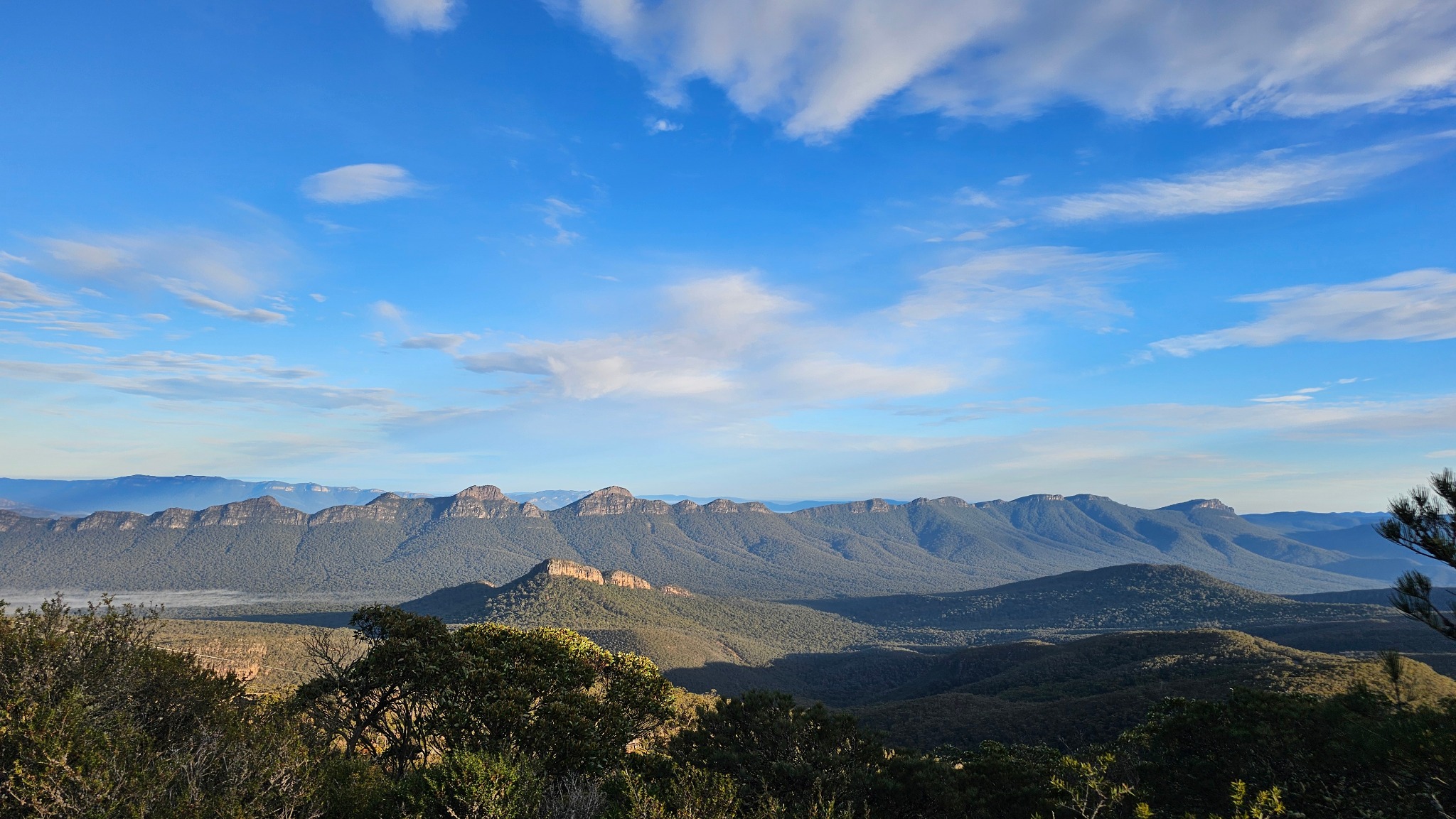 Wide mountain range beneath a blue sky