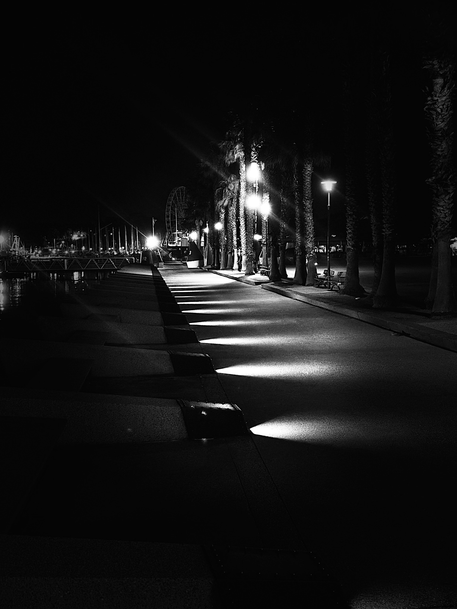 Black and white illuminated pier at night