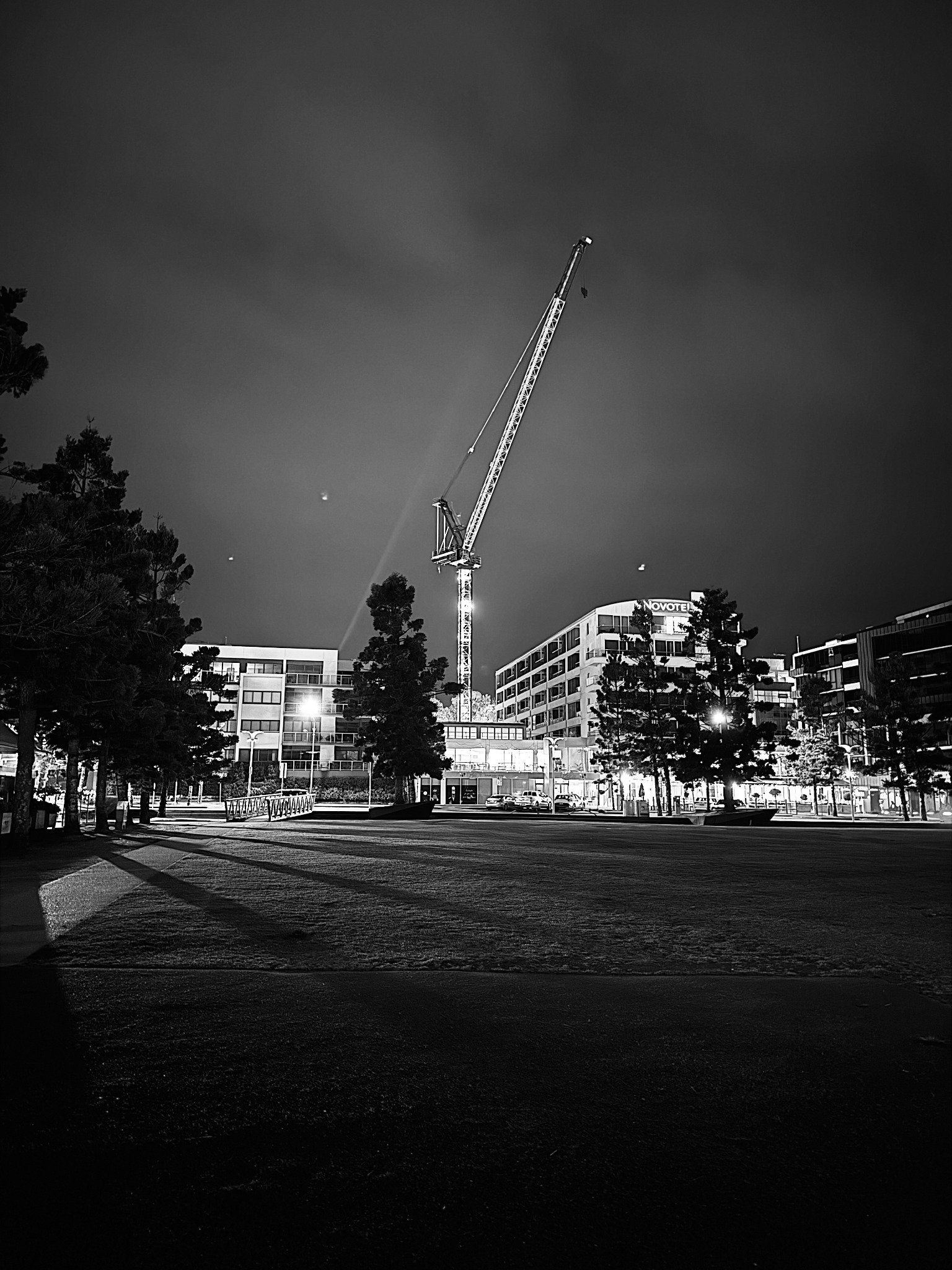 Moonlit waterfront beneath clouds